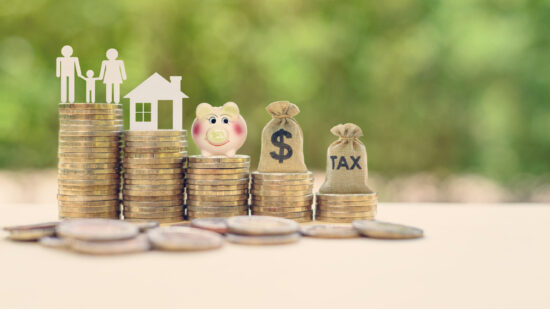 Family couple, home model, piggy bank, dollar and tax bags on stacks of rising coins